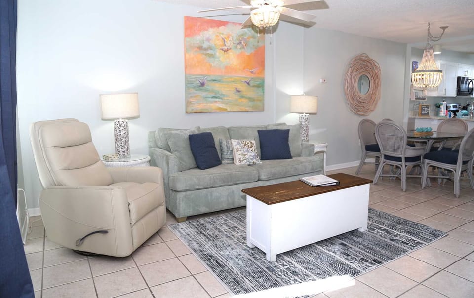 The cozy living room includes a sleeper sofa & recliner.
