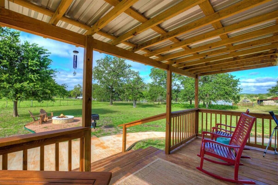 The porch, adorned with inviting rocking chairs, beckons tranquility as gentle breezes and the rhythmic sway of chairs create a perfect symphony for moments of quiet reflection and shared conversations.