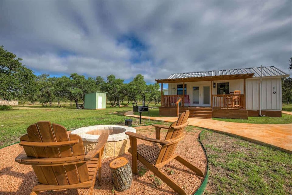 The cozy firepit invites warmth and connection, where flickering flames dance under the night sky, creating a perfect spot for shared stories and quiet moments.