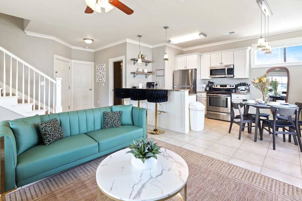 Open living area with kitchen, dining space, and relaxed coastal seating