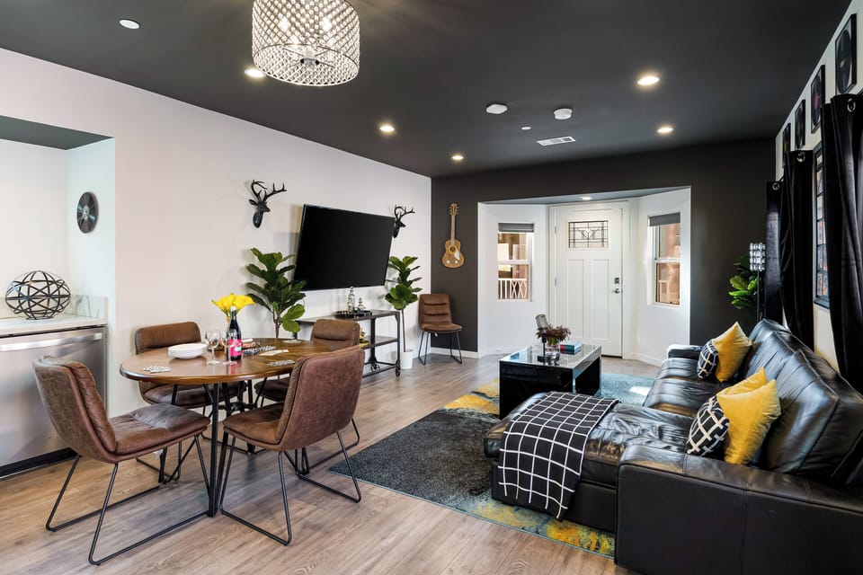 Sleek, open-concept living and dining area featuring modern finishes, cozy seating, and stylish lighting—perfect for relaxing nights in or gathering with friends. (Rock n Roll)