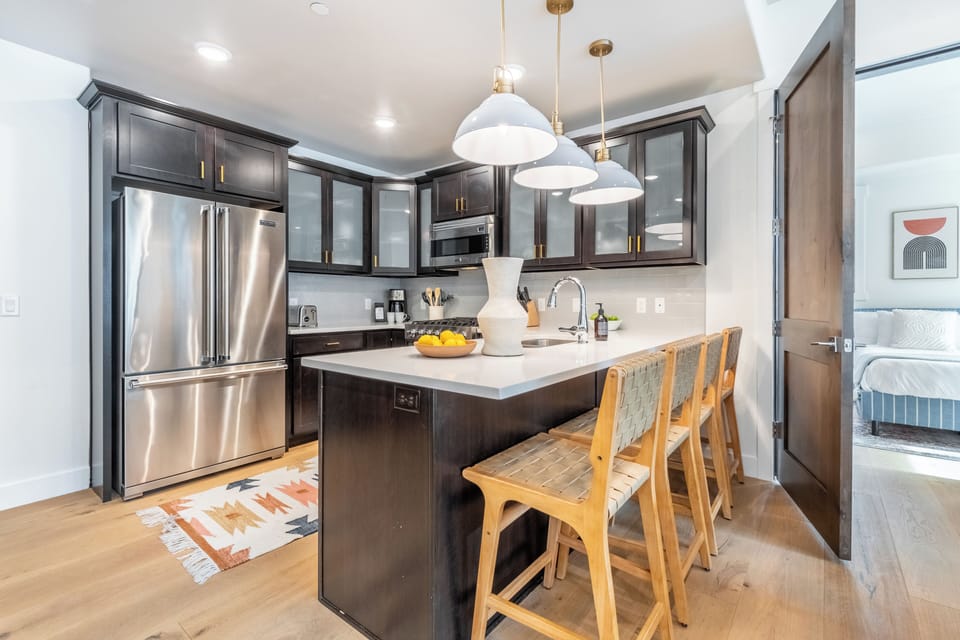 Kitchen with a large fridge and tons of counter space.