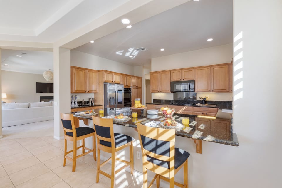 Fully equipped kitchen with additional barstool seating.
