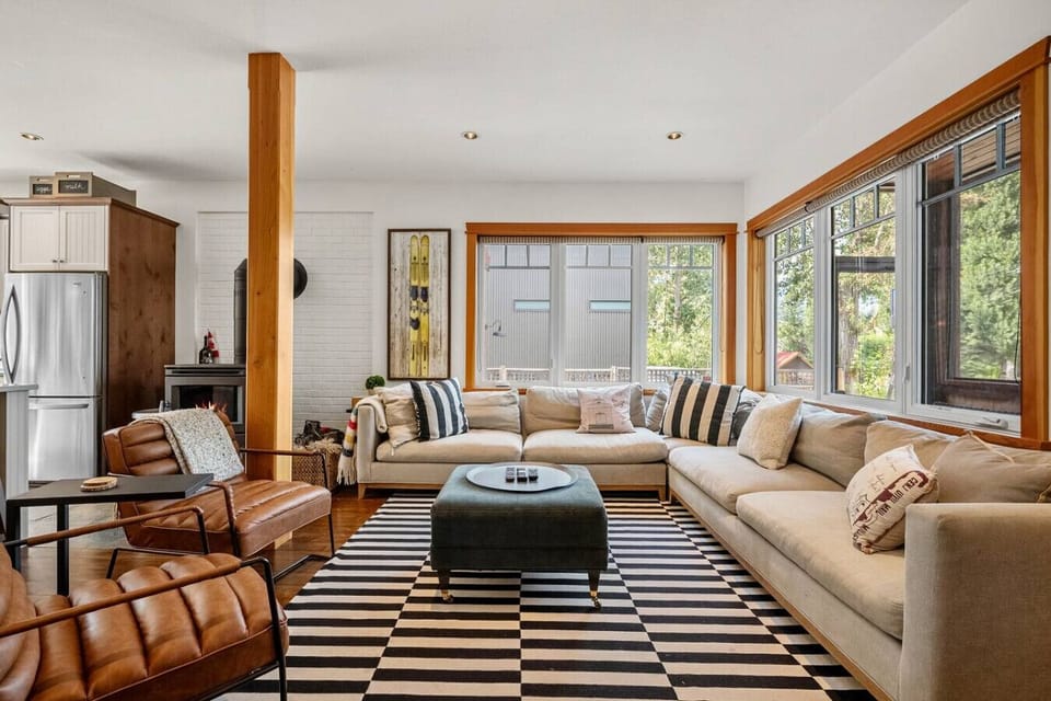 Main floor living room with cozy seating options, a 40` TV with cable, wood-burning fireplace and board games.