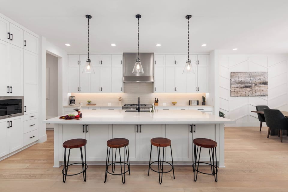 Fully equipped kitchen with stainless steal appliances and a kitchen island with bar seating for 4 guests.