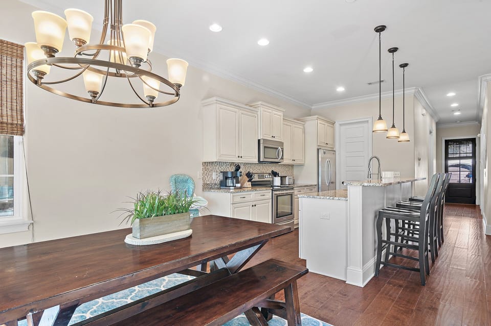This inviting open-concept space features a beautifully designed kitchen with granite countertops, stainless steel appliances, and ample cabinetry.