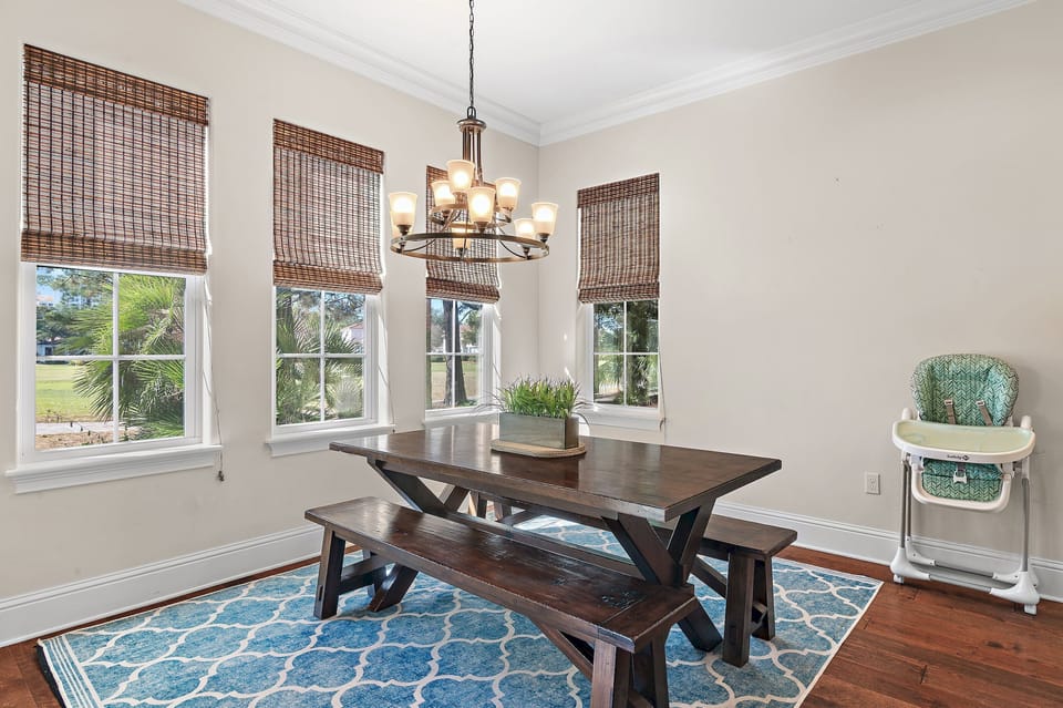 Gather around the dining table surrounded by natural light and peaceful Sandestin views.