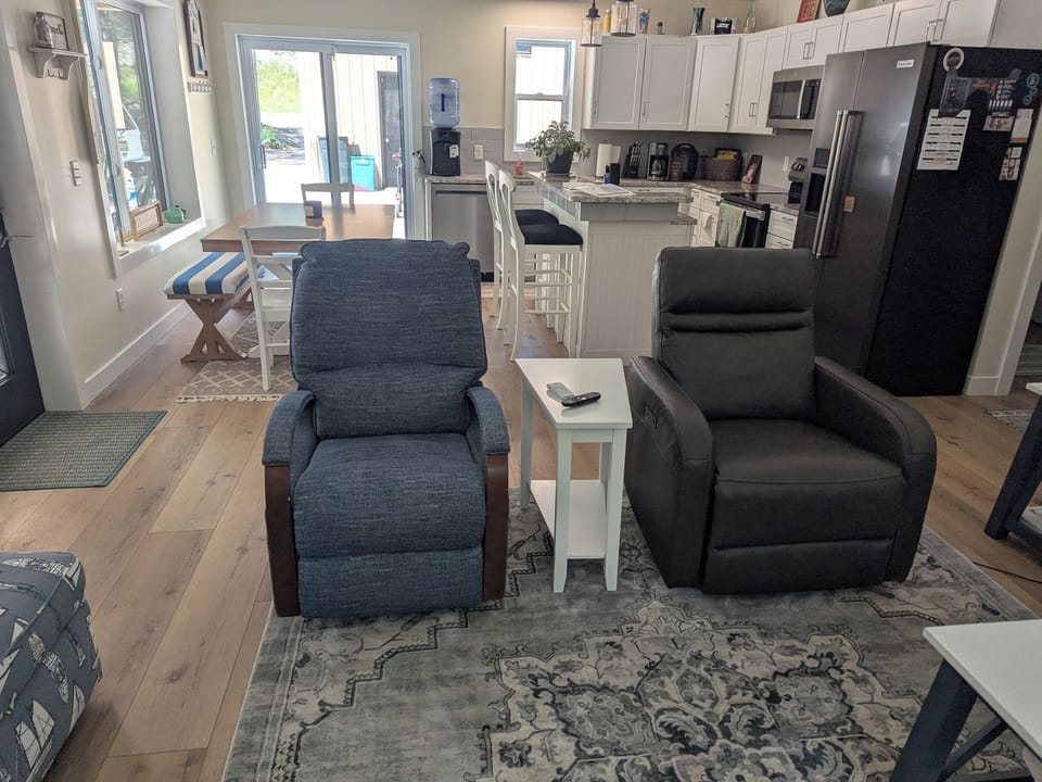 LIVING AREA LOOKING INTO FULLY EQUIPED KITCHEN
