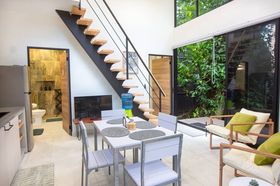 Open-concept living and dining area at Somnara Bosque Tropical, Playa Chiquita, Costa Rica.