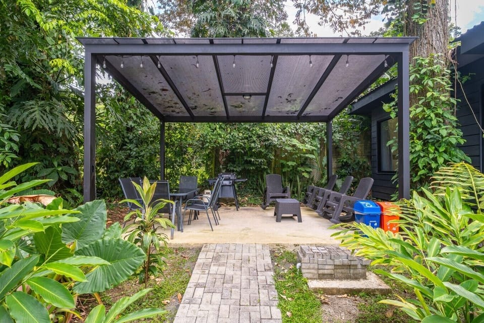 Covered outdoor seating and BBQ area surrounded by tropical gardens, Somnara Bosque Tropical, Playa Chiquita