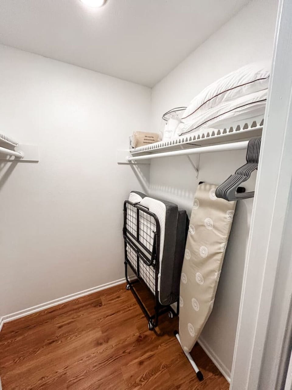 Spacious closet with hangers for easy storage.