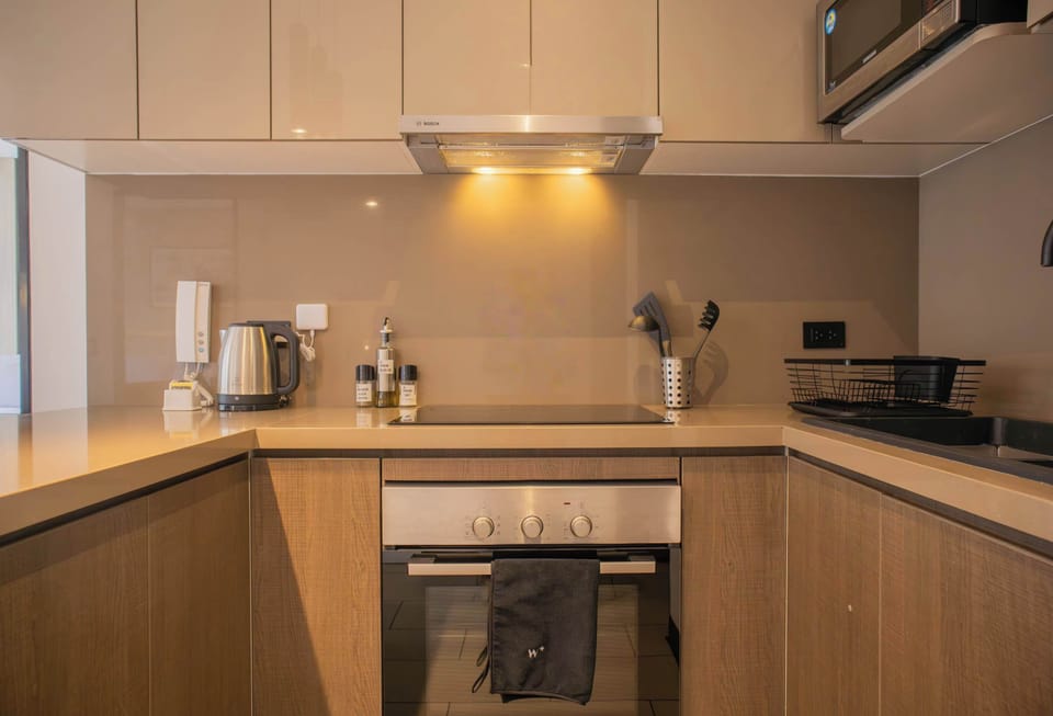 Contemporary kitchen with wooden cabinets and lighting.