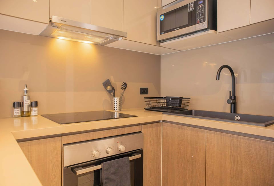 Kitchen counter with built-in stove and overhead cabinets.
