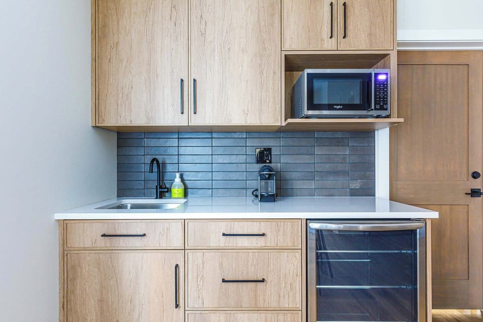 Kitchenette with Nespresso coffee machine, microwave and bar fridge
