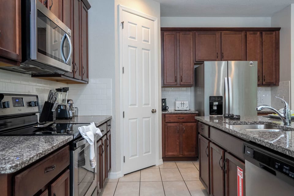 Enjoy gourmet convenience in this fully stocked kitchen with stainless steel appliances, ample counter space, and a sleek, functional design.