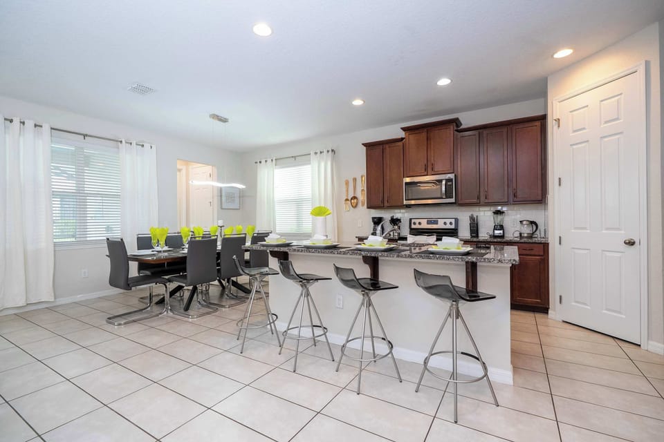 Enjoy easy entertaining with an open kitchen, breakfast bar seating, and an adjacent dining area for unforgettable family gatherings.