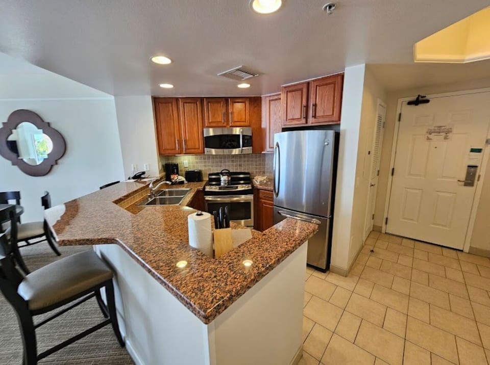 Full kitchen includes a stackable washer & dryer