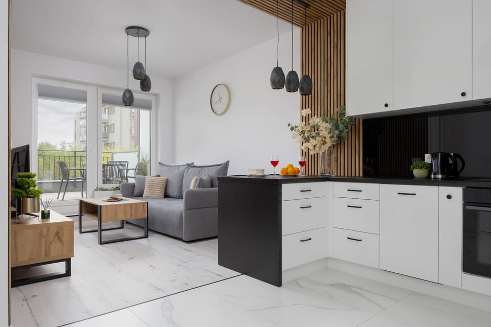 The open kitchen area flows seamlessly into the living room, creating perfect conditions for both cooking and relaxing together.