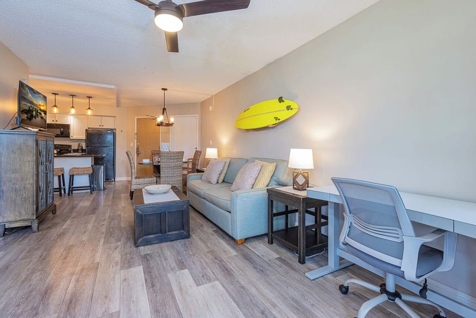 Work or relax—adjustable desk, sofa sleeper, and island décor