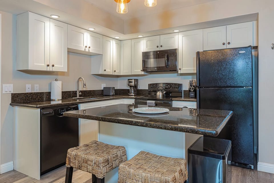 Modern kitchen with island, bar seating, and full appliances