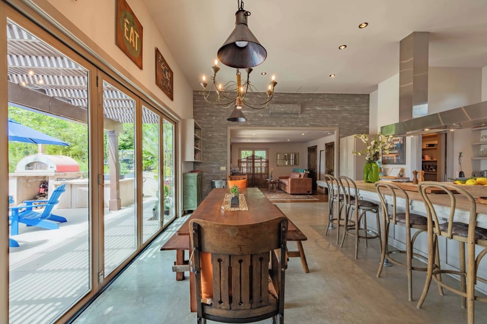 Step into an open-concept haven where rustic charm meets modern elegance. Gather around the farmhouse table or perch at the kitchen island—your perfect space for meals and memories.