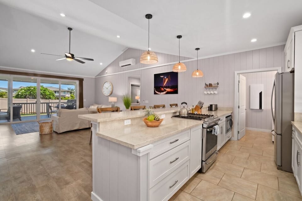 Main house: Open-concept kitchen and living area with large island, natural light, and easy access to the outdoor space.