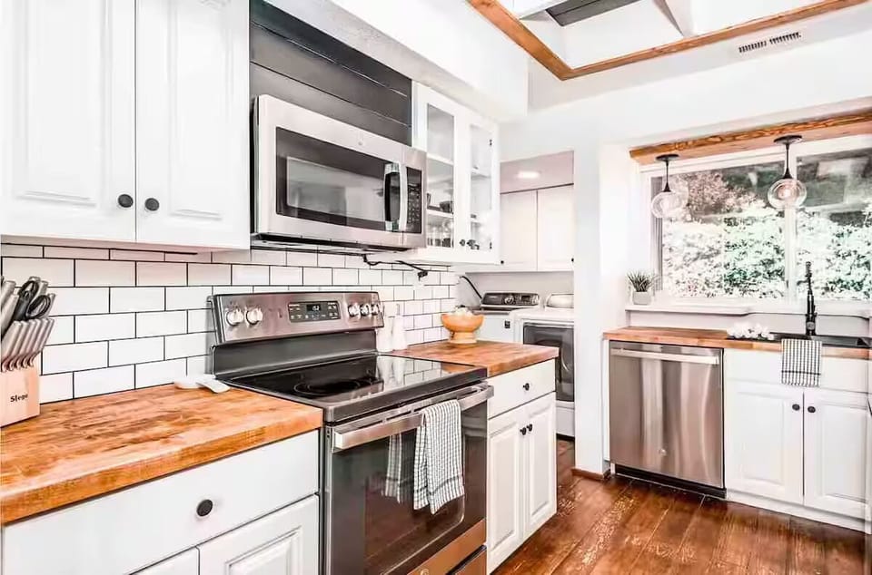 Full modern kitchen with appliances, sink, refrigerator, coffee maker and more