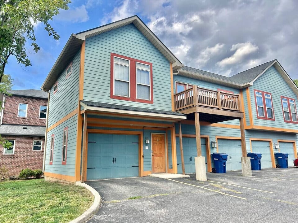 View of the front of the townhome when you pull up. One parking spot inside the garage and one parking spot outside of the garage.