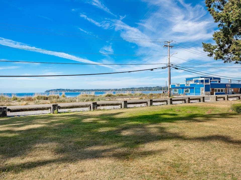 Spacious waterfront lawn with stunning ocean views and pier access