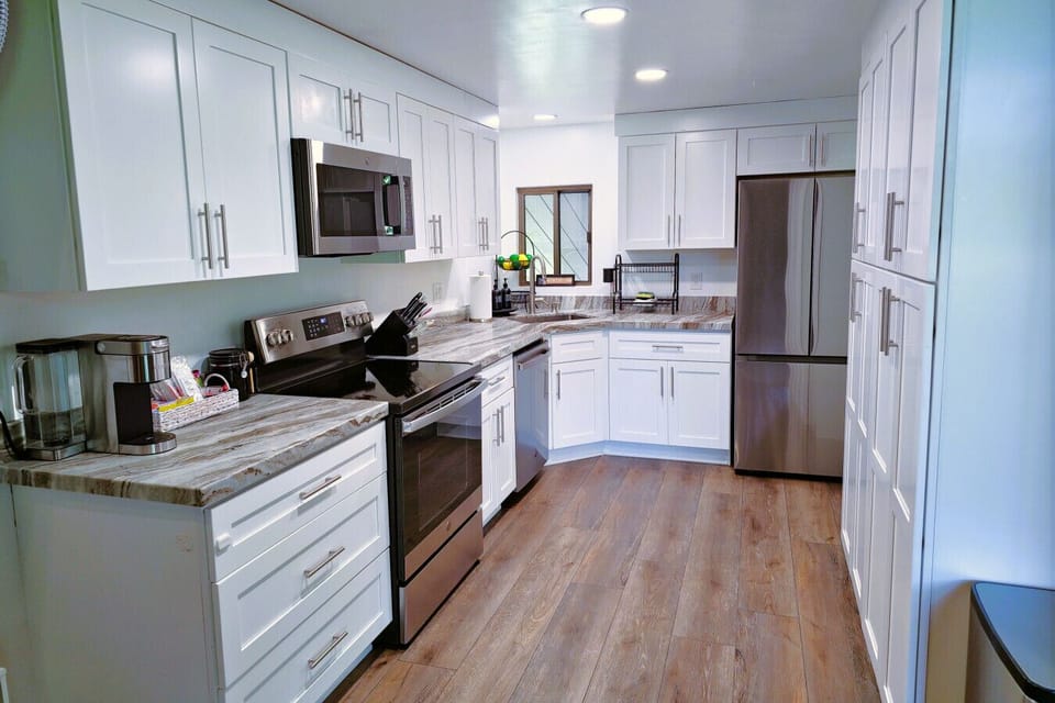 Kitchen: Modern space with sleek appliances and elegant countertops for culinary adventures!