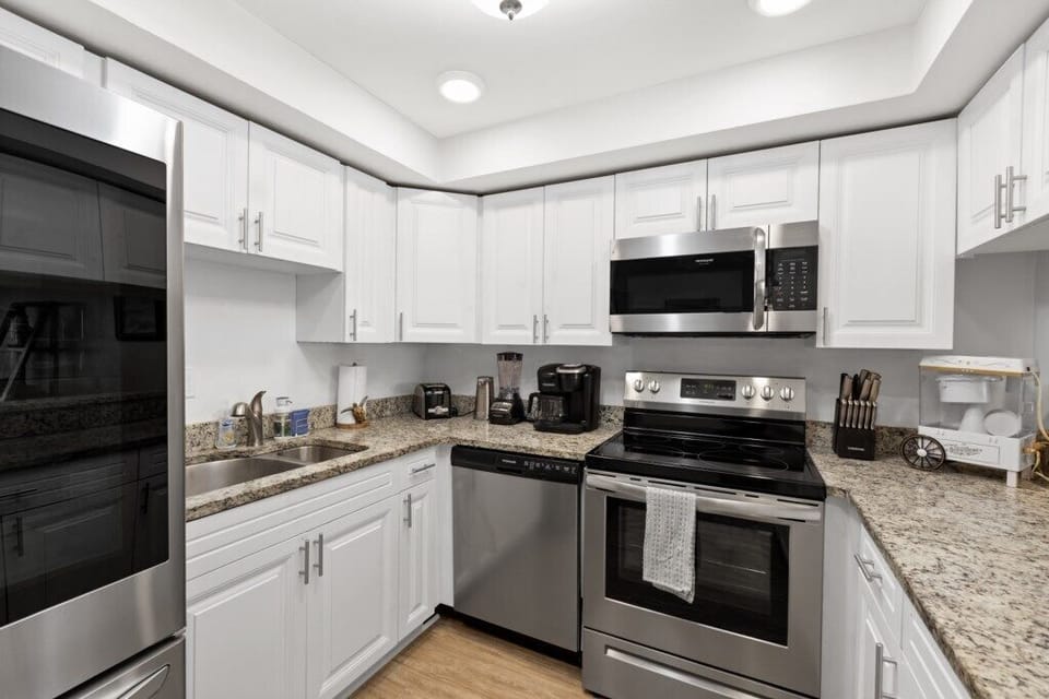 Modern kitchen with stainless steel appliances and spacious countertops.