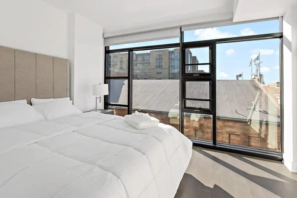 Queen bedroom with floor to ceiling windows