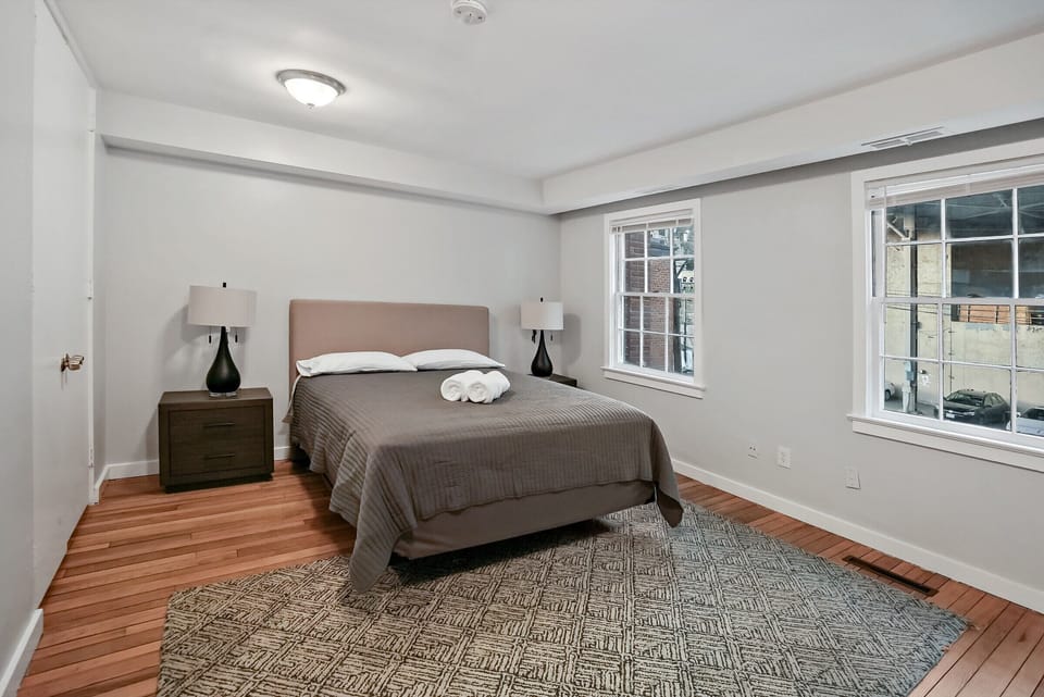 Queen bedroom with an exposed-brick accent wall