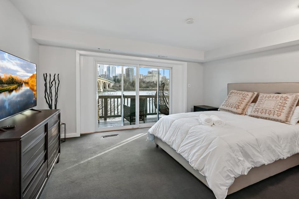 Bedroom with direct balcony access and river view