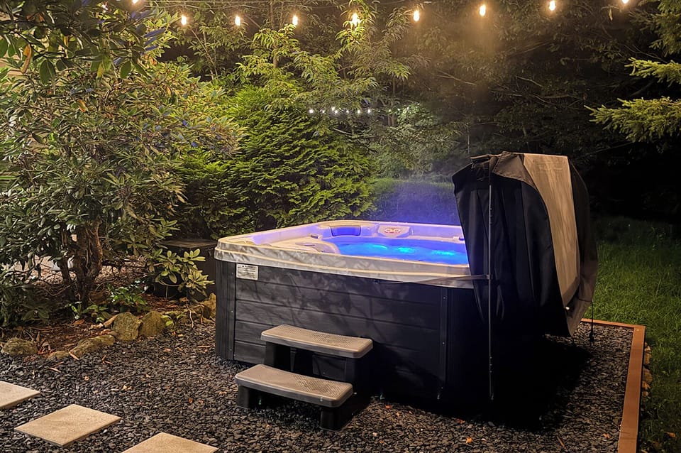 Private outdoor hot tub glowing under the stars.