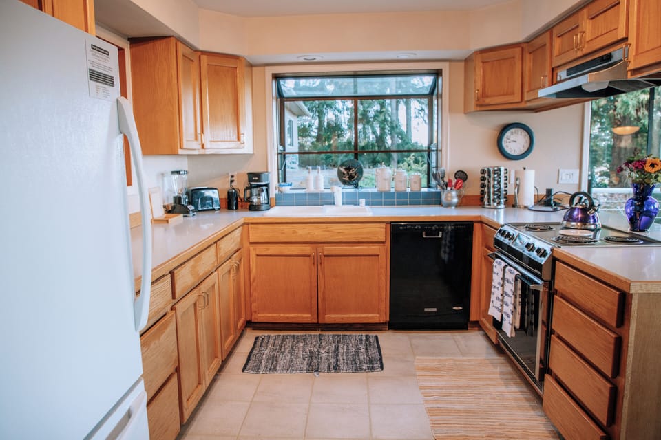 Spacious full kitchen stocked with cookware, dishes, and essentials.