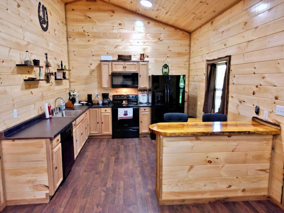 Cook with ease—fully stocked with all the essentials, plus two types of coffee makers, stove top, oven, and microwave for hearty home cooked meals.  There is a small dining table plus barstool seating facing the TV to enjoy a meal. 