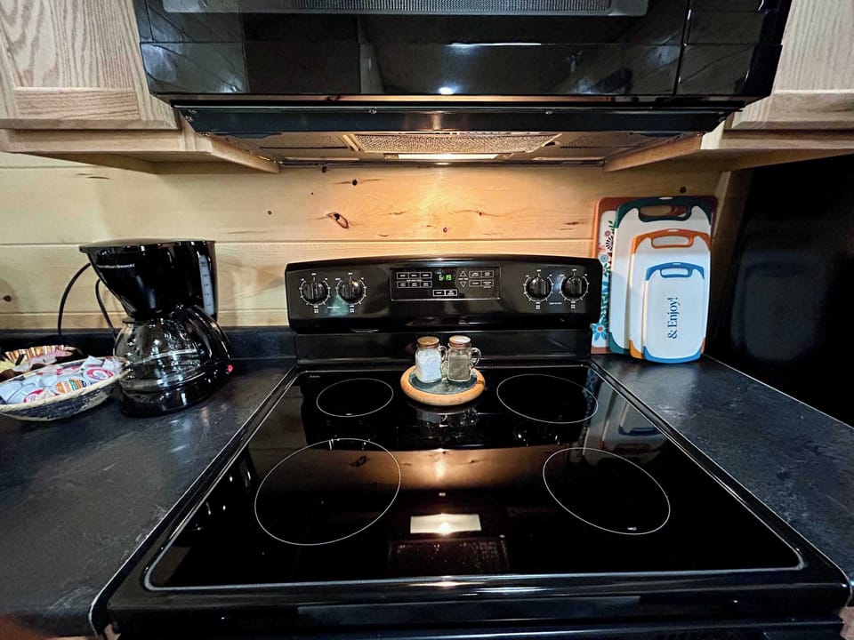 4 burner electric stove, oven, microwave, and all the basic kitchenware you could need to cook at the cabin for your getaway. 