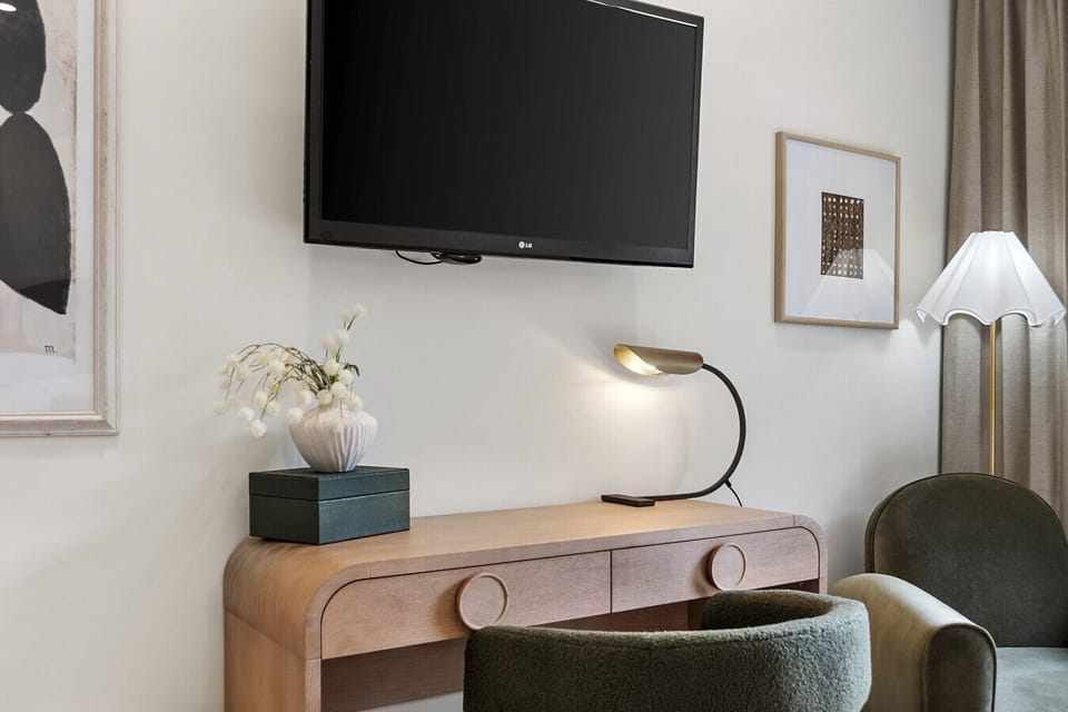 A stylish workspace for remote travelers, complete with designer lighting, a smart TV, and calming décor to keep you focused and inspired.