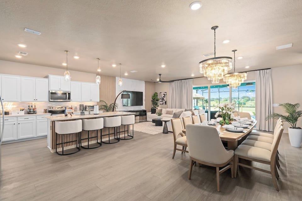 Open dining and kitchen - chandeliers, seating for ten, and room for everyone at dinner.