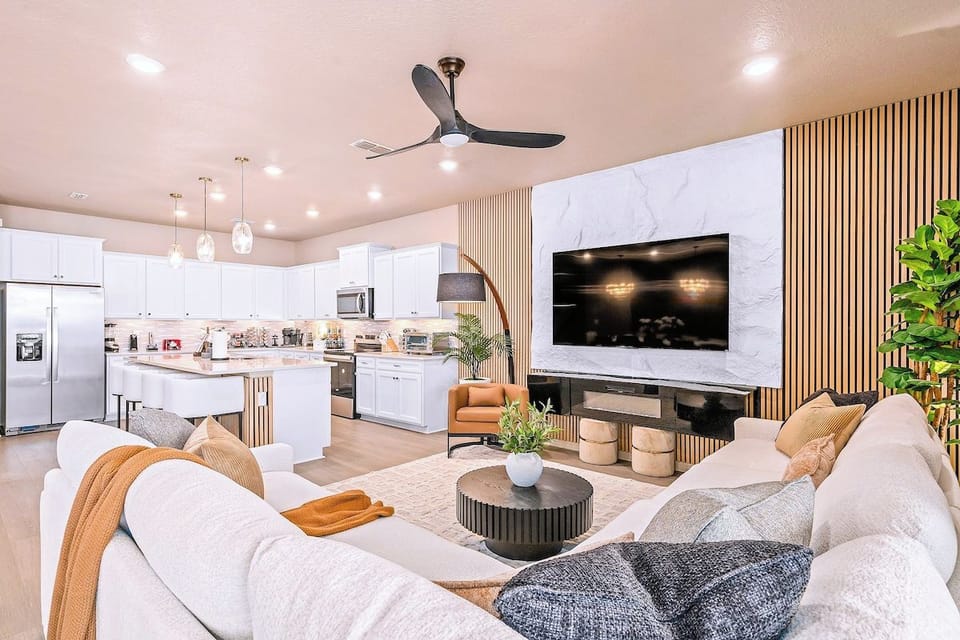 Open concept great room - gourmet kitchen, oversized sectional and wall mounted TV, styled for a crowd of 28.