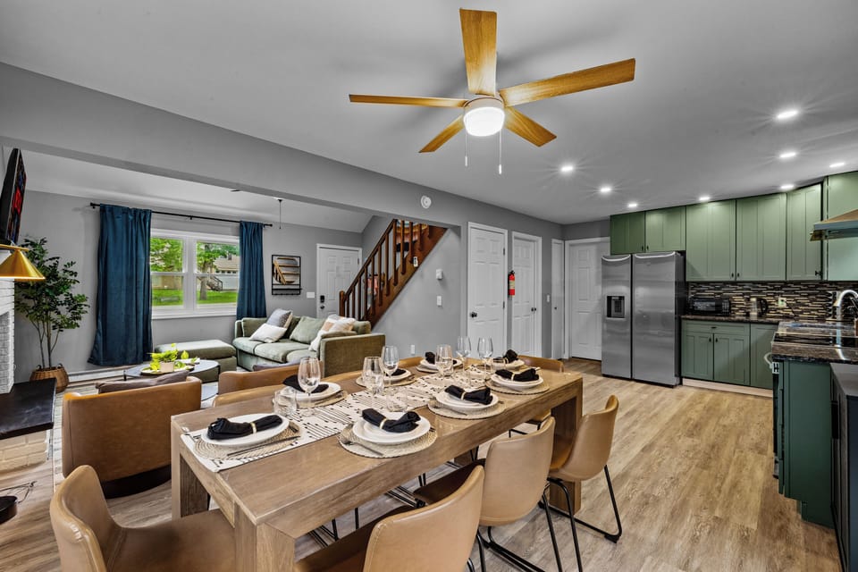 Spacious open-concept layout featuring a large dining table set for eight
