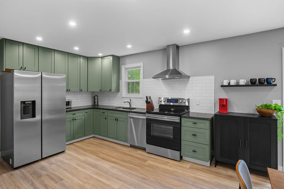 Modern, fully equipped kitchen with sleek stainless steel appliances,