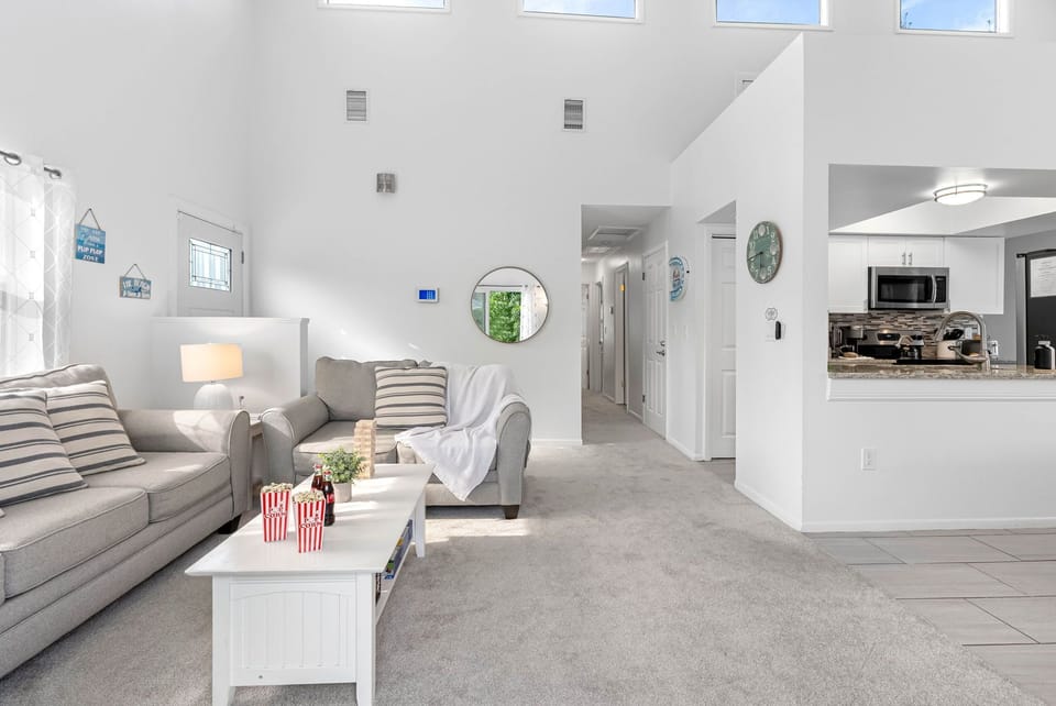 Sunlight fills this open-concept living space, where cozy seating and modern touches create the perfect place to relax with family and friends.