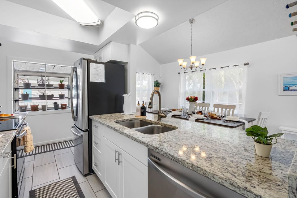 This fully equipped kitchen features stainless steel appliances, granite countertops, and a stylish backsplash — perfect for whipping up family meals.