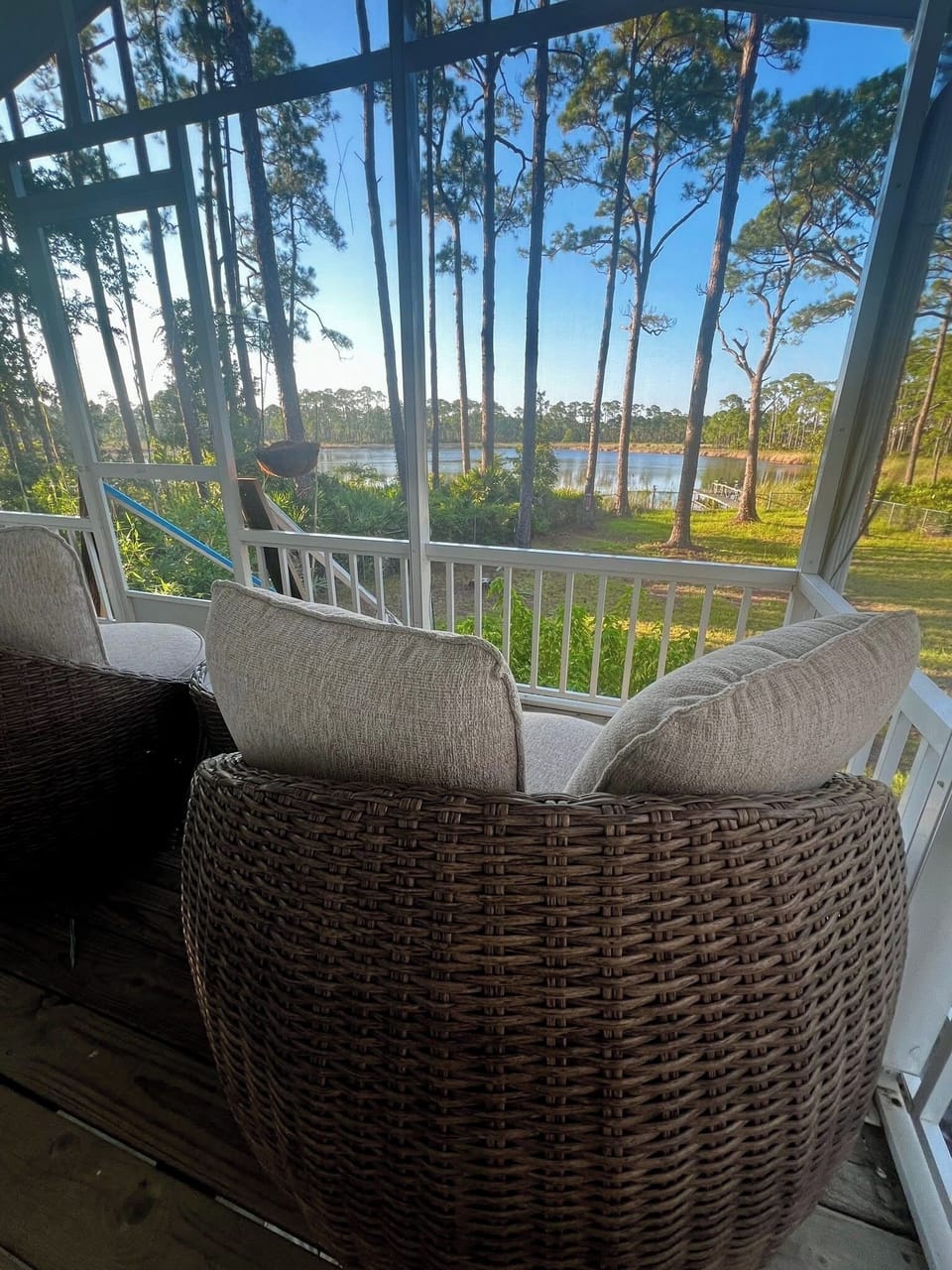 Upstairs screened in balcony with swivel egg chairs.