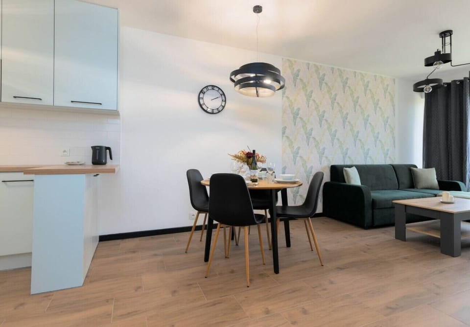 Dining and Living Space with Stylish Wallpaper, Comfortable Sofa, and Cozy Ambiance | Book Now with RENTUJEMY.COM