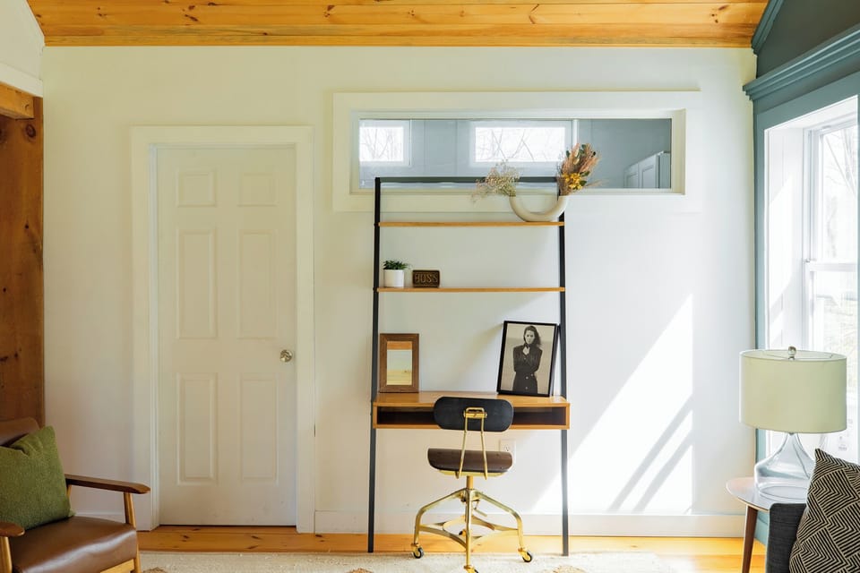 Office nook in the main living room with door to laundry room 