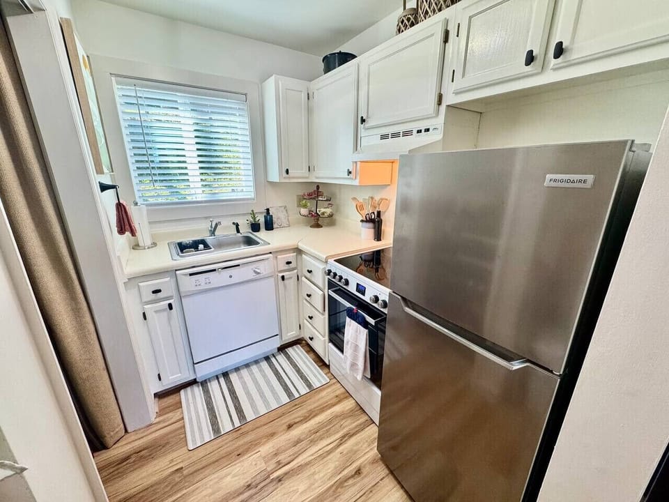 Kitchen w/ basic cooking items & coffee station.
