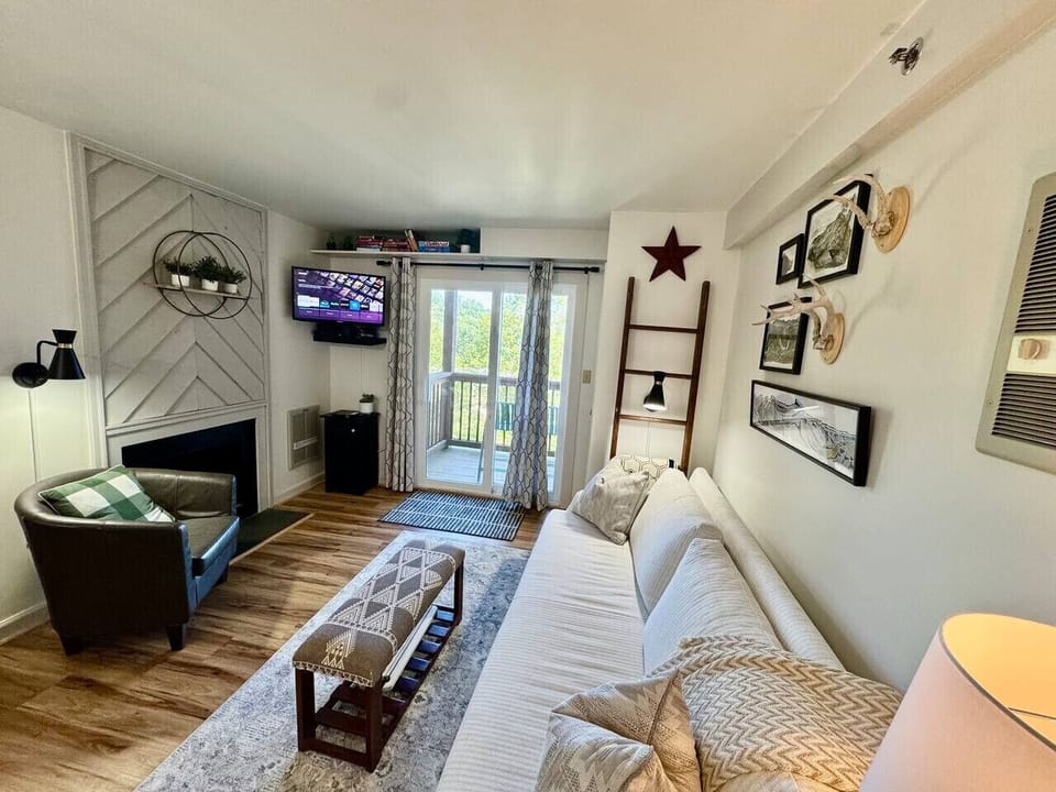 Comfy living room w/ smart TV, pull out couch, and private deck.